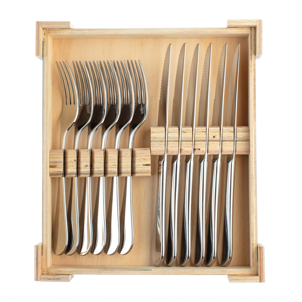 Set of silver steak forks and knives in a wooden holder on a white background