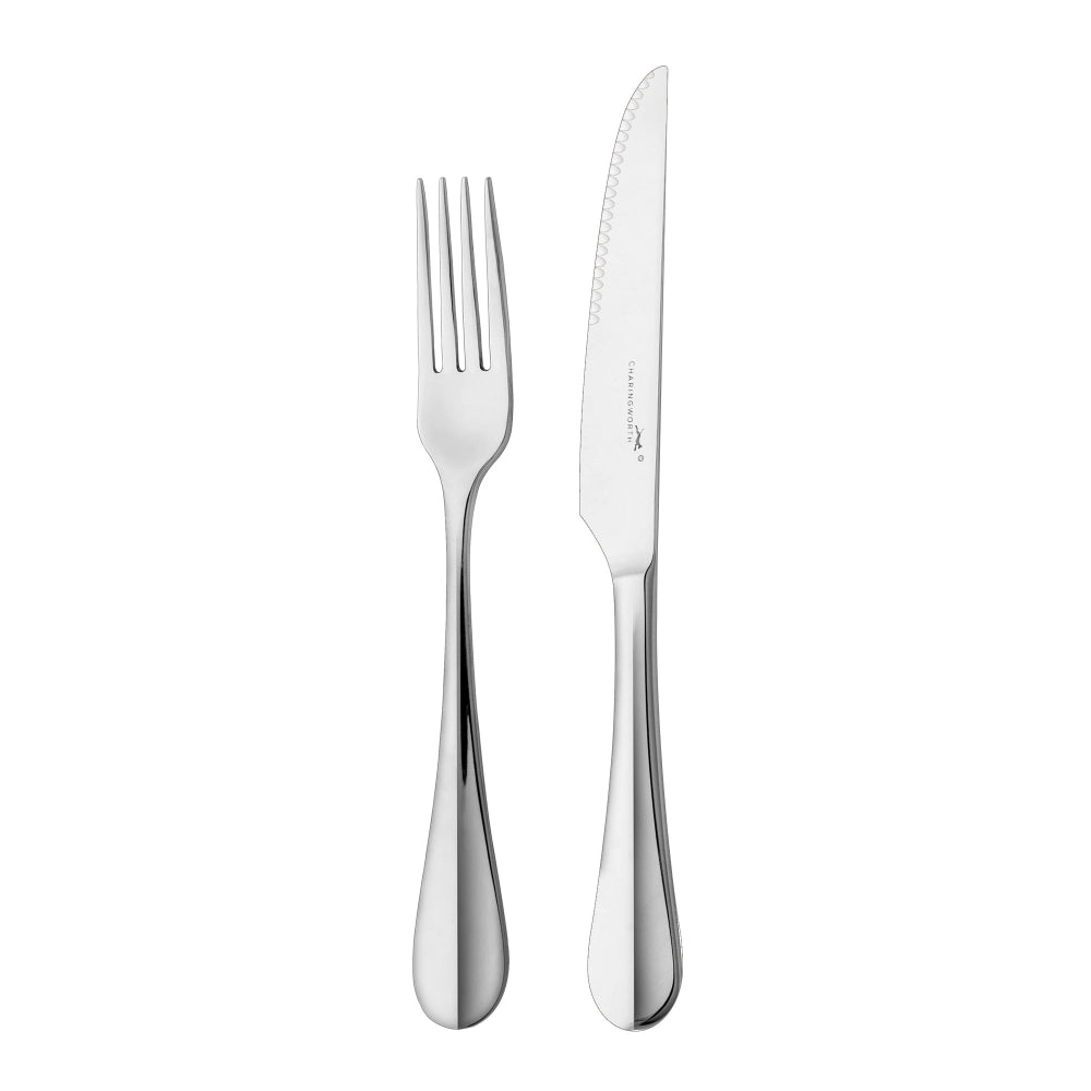 A steak knife and fork set with polished stainless steel finish and a common design on a white background.
