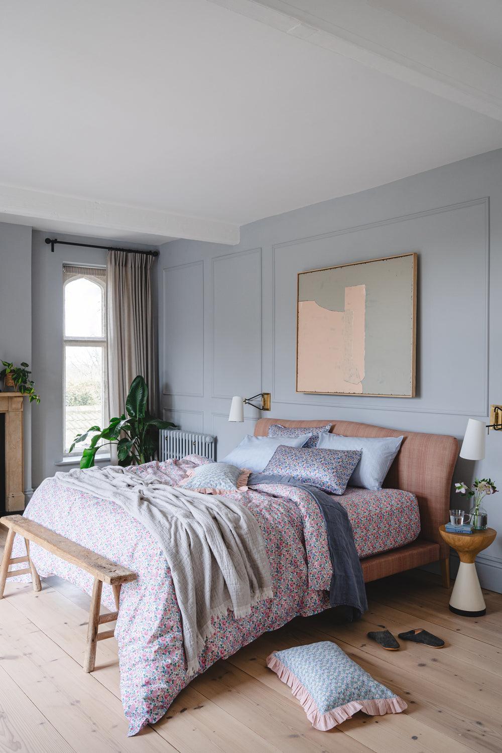 Cozy bedroom with a bed, lamp, and decor elements.