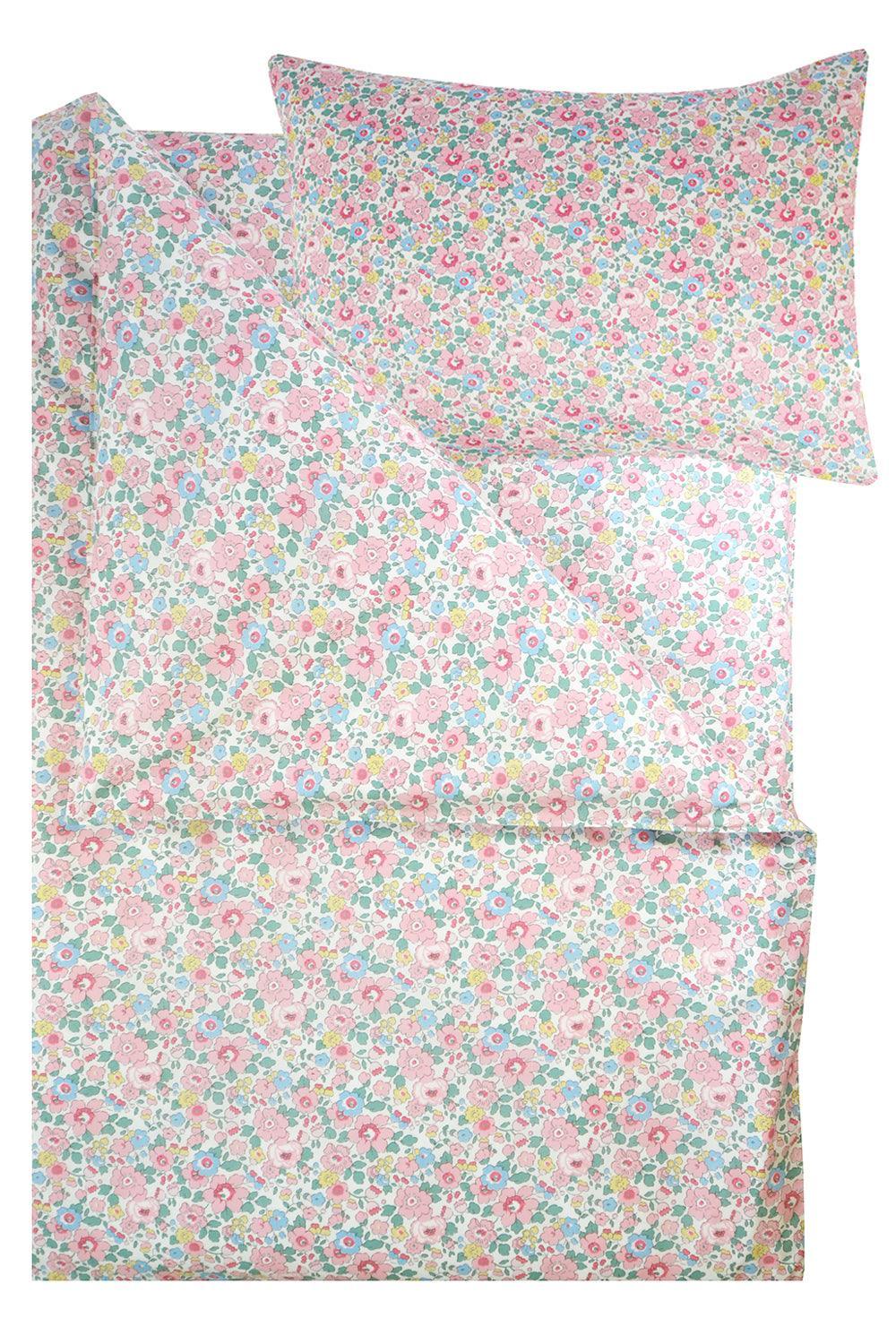 Floral patterned bed sheet set with matching pillowcase on a white background