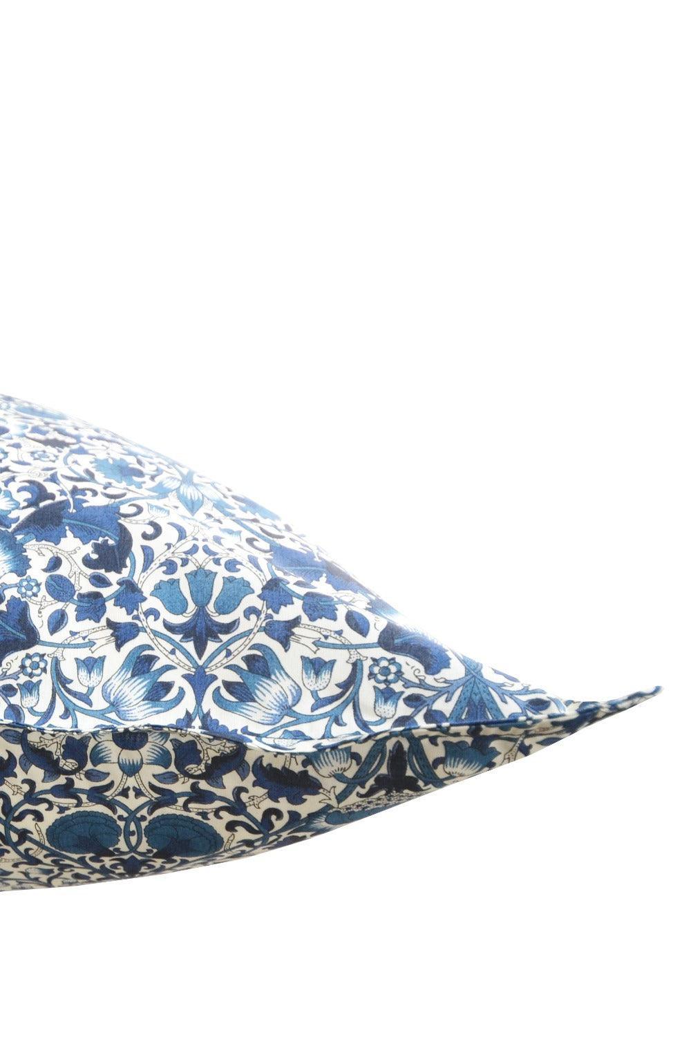 Decorative pillow with liberty blue floral pattern on a white background
