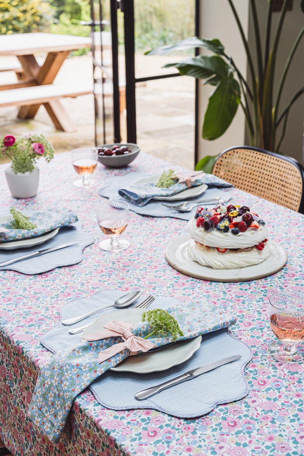 Outdoor table setting with a dessert and floral tablecloth