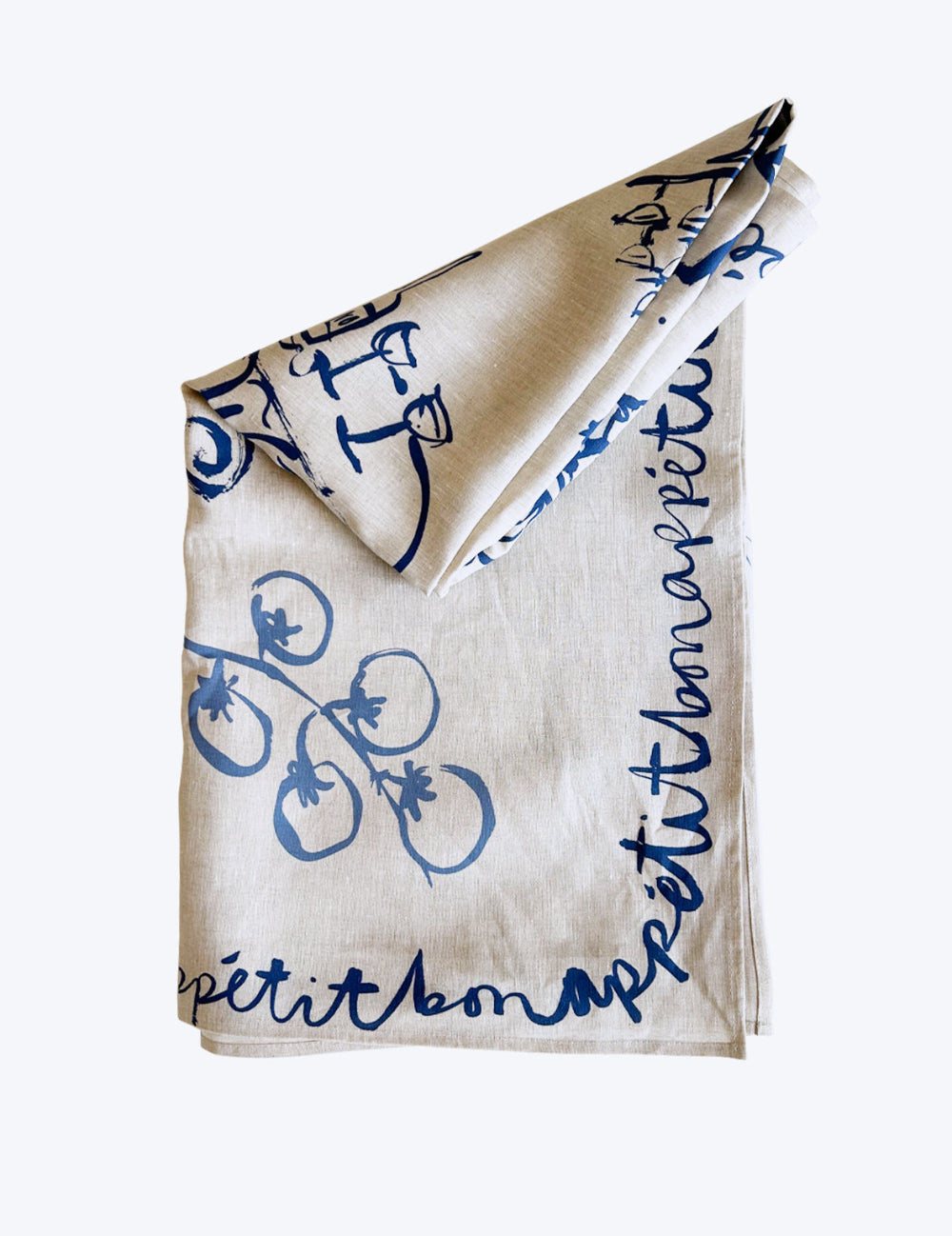 Beige linen tablecloth with blue french inspired illustrations and text design on a white background