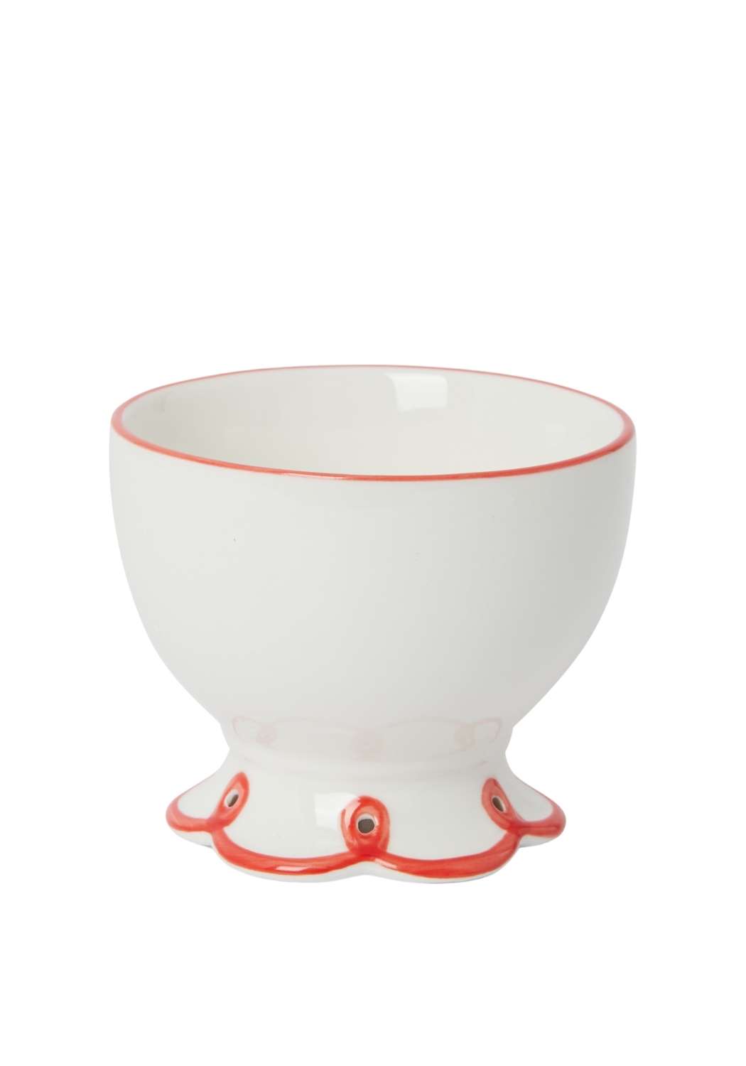 White ceramic bowl with red scalloped bottom on a white background
