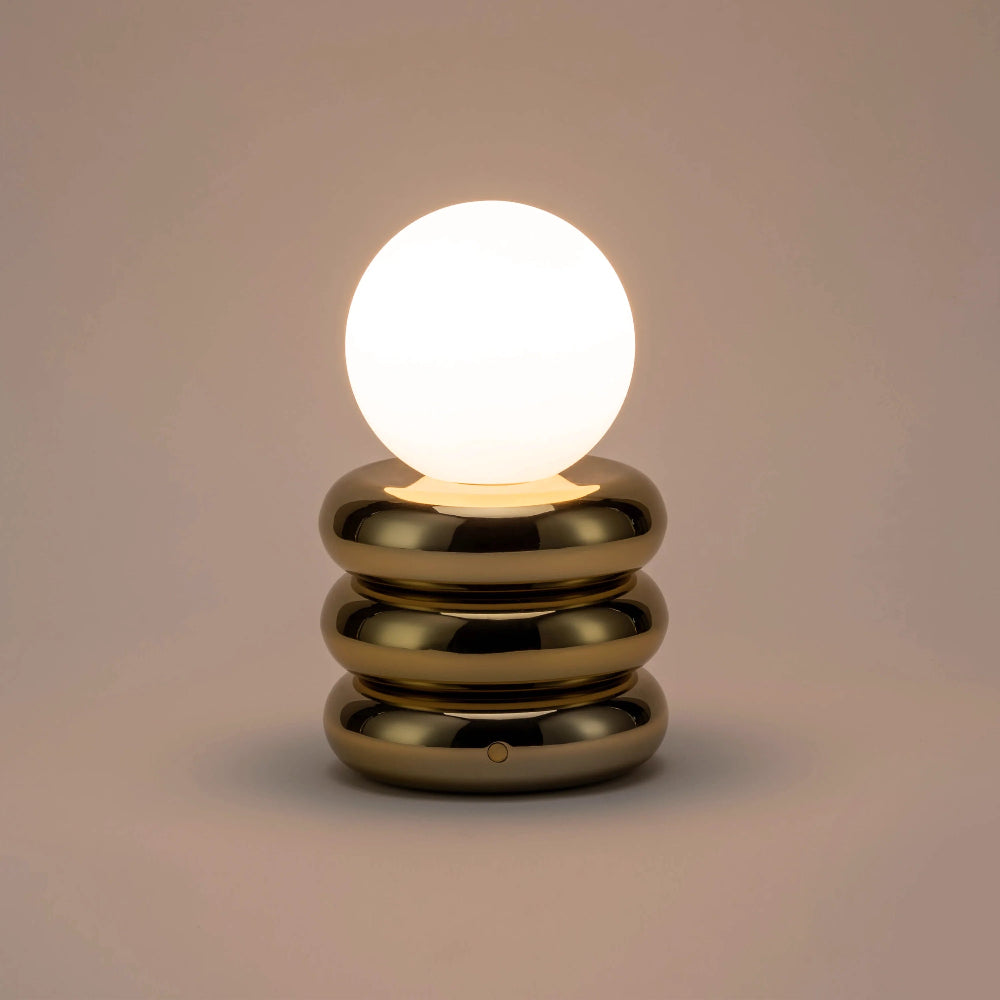 Front view of the rechargeable brass table lamp showing its compact design