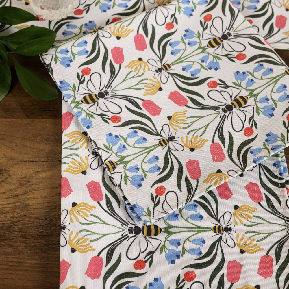 Floral and bee patterned fabric on a wooden surface