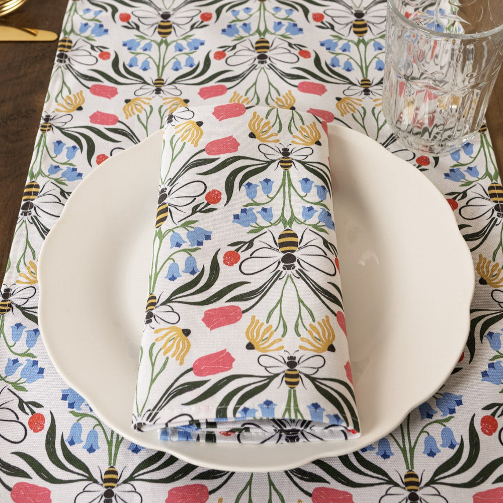 Napkin with floral and bee pattern on a matching tablecloth