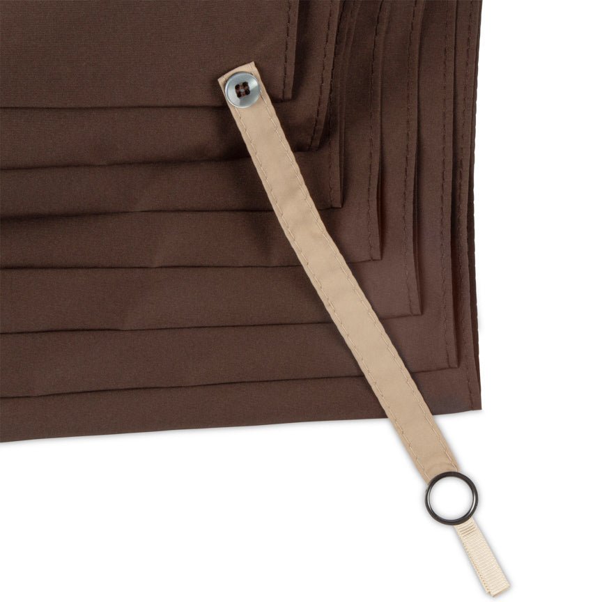 Brown fabric with a beige strap and black ring on a white background