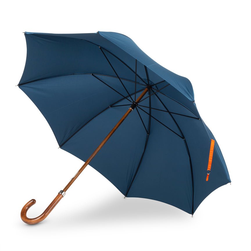 Blue umbrella with a wooden handle on a white background
