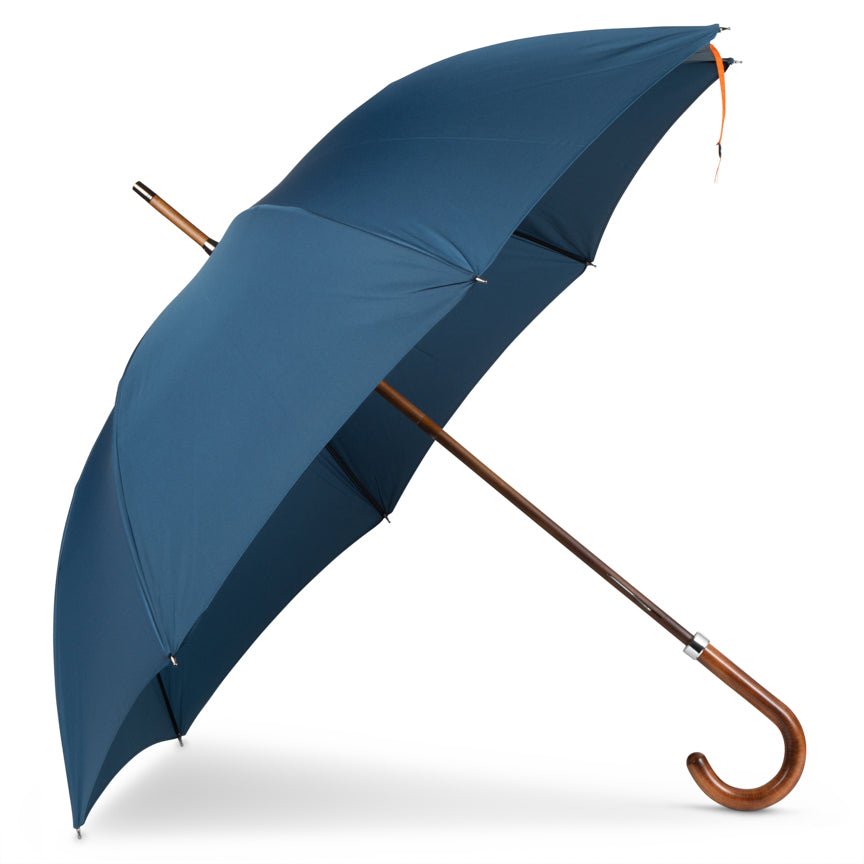 Blue umbrella with a wooden handle on a white background