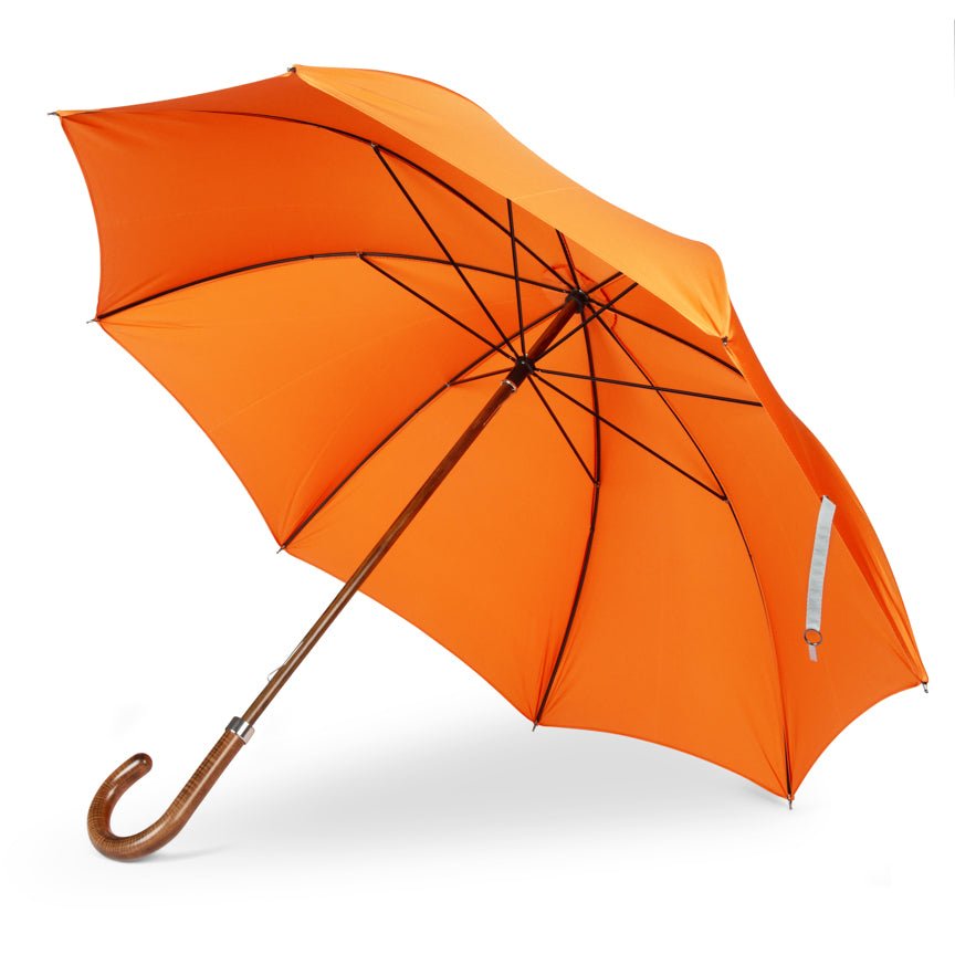 Orange umbrella with a wooden handle on a white background
