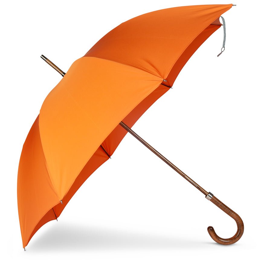 Orange umbrella with a brown handle on a white background