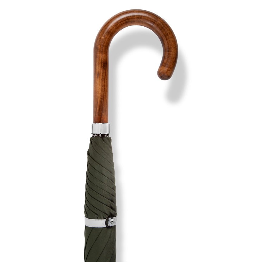 Green umbrella with wooden handle and silver accents on a white background