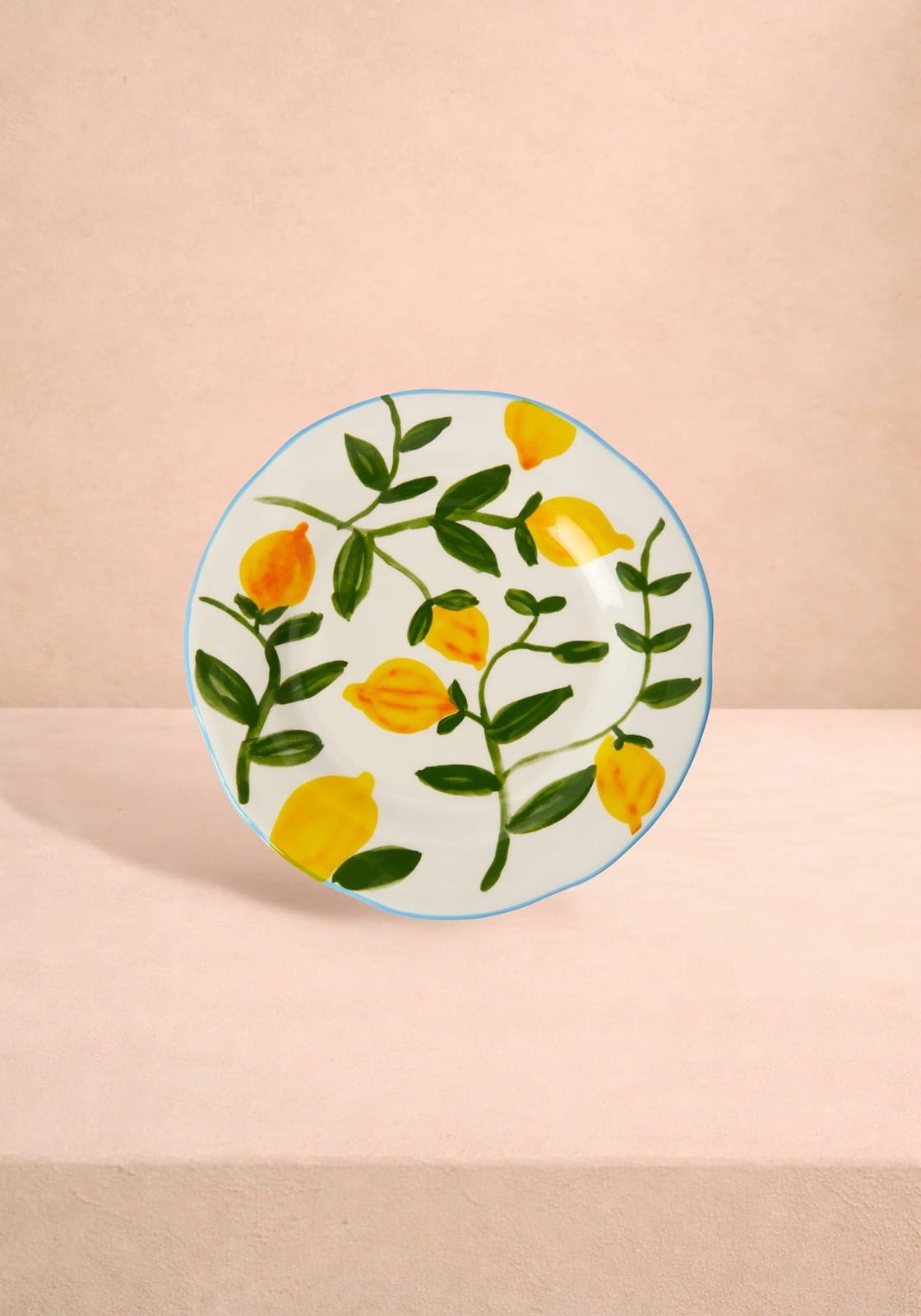 Decorative plate with lemon design on a beige background