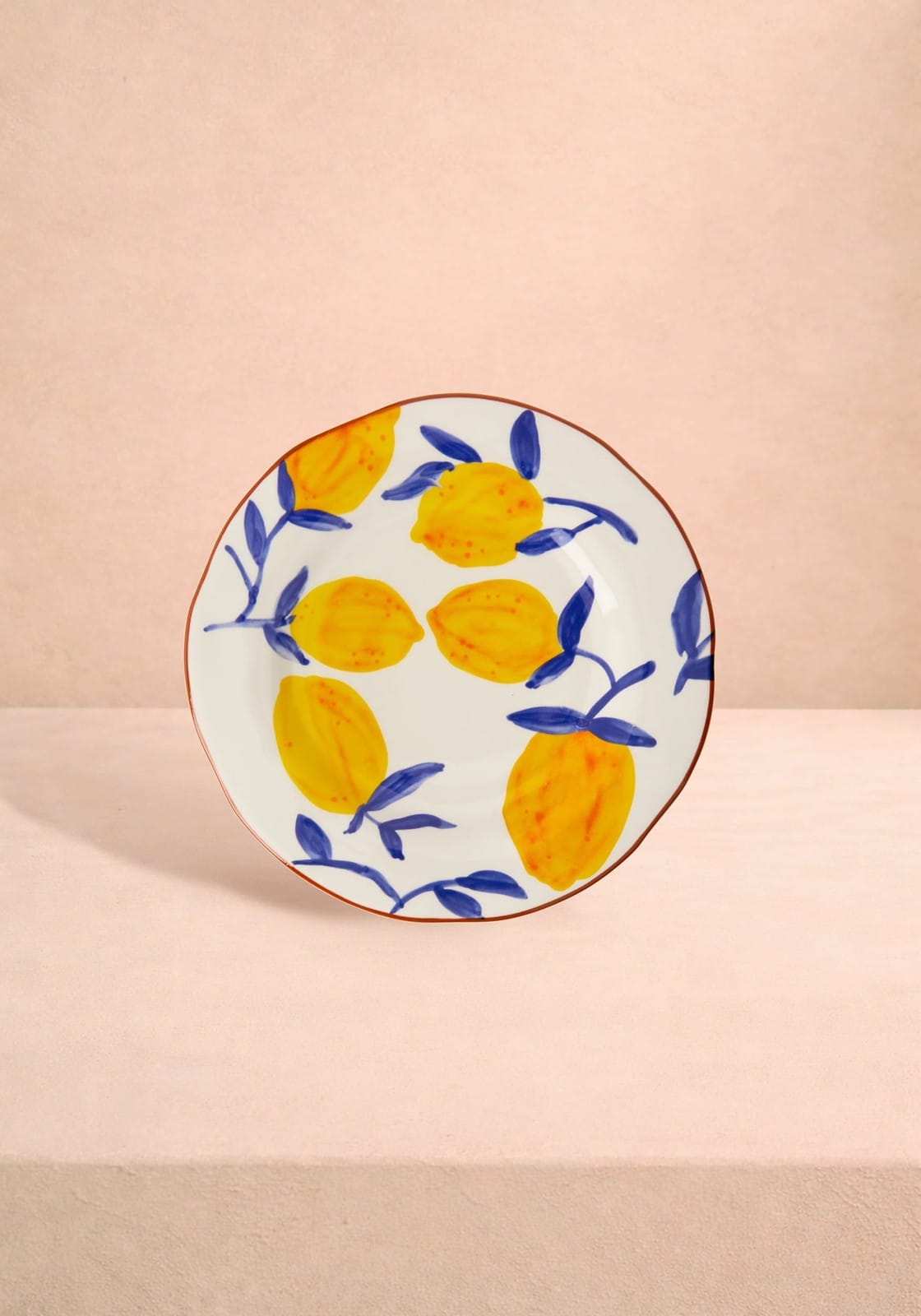 Decorative plate with lemon pattern on a beige background