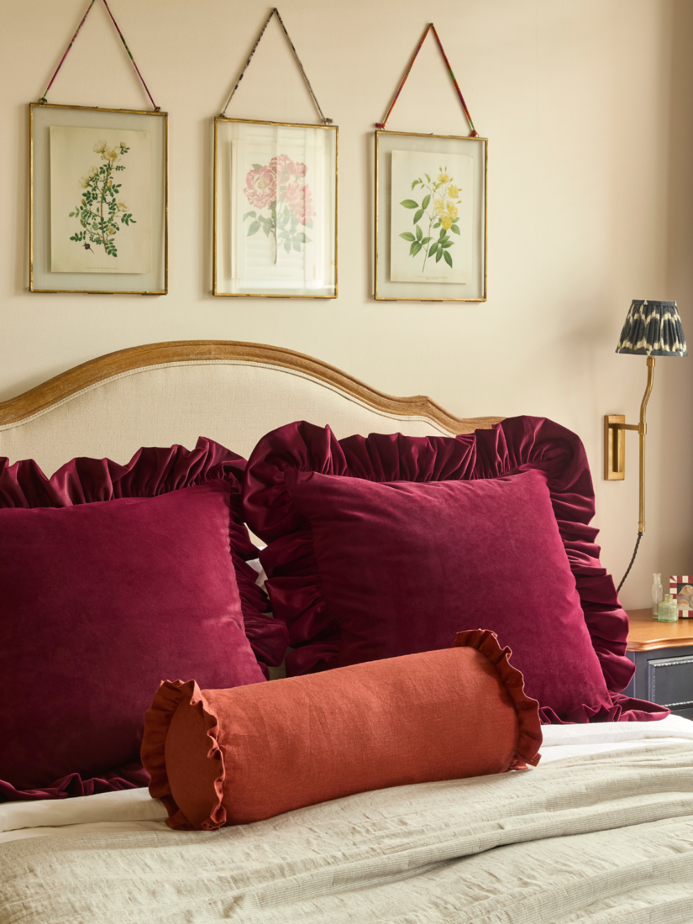 Burgundy 60 x 60cm velvet cushion with gathered ruffle styled in a bedroom