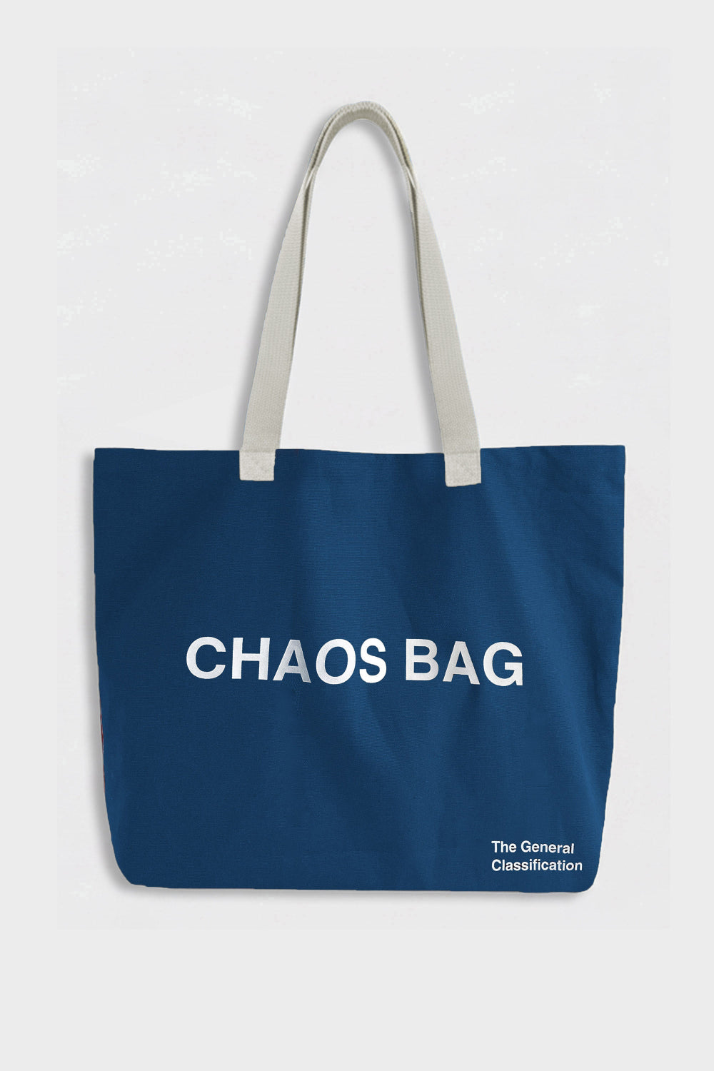A navy blue canvas tote bag with light beige shoulder straps and white printed text reading 'CHAOS BAG' on the front, with smaller text 'The General Classification' in the bottom right corner, set against a light gray background.
