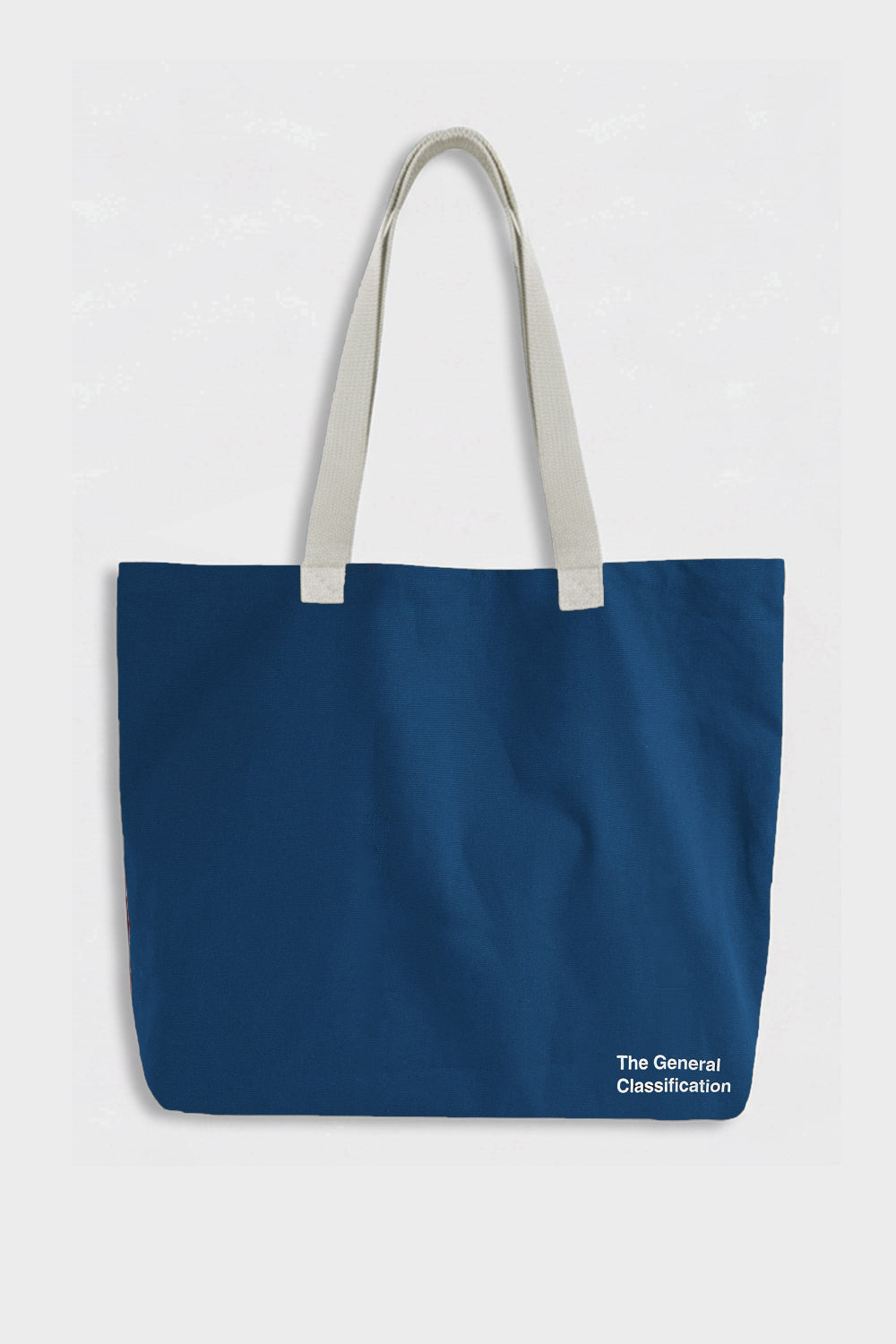 A navy blue canvas tote bag with light beige shoulder straps and a small white logo reading 'The General Classification' in the bottom right corner, set against a light gray background.