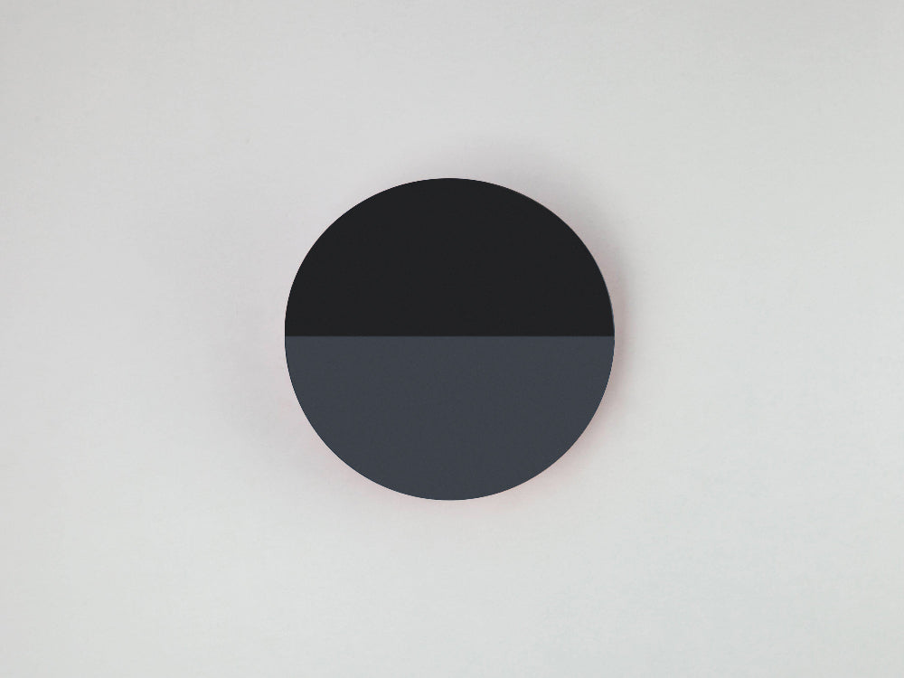 Charcoal grey diffuser wall light styled in a contemporary interior