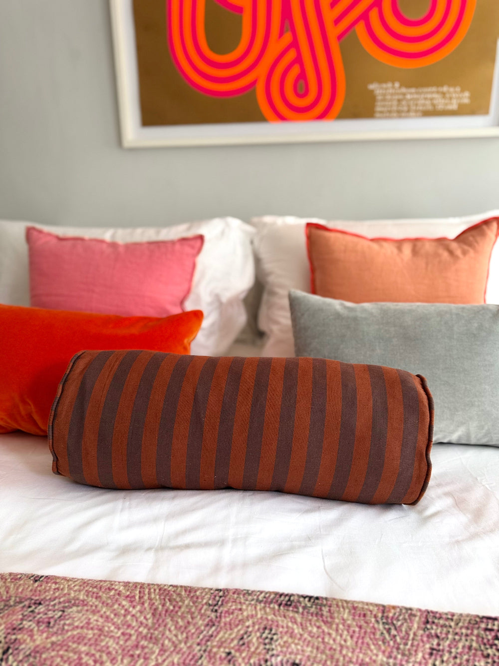 Chocolate and rust striped bolster cushion with piped edge by Kika Bespoke