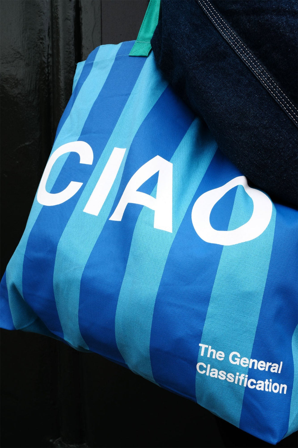 Blue striped bag with 'CIAO' and 'The General Classification' text on a black background