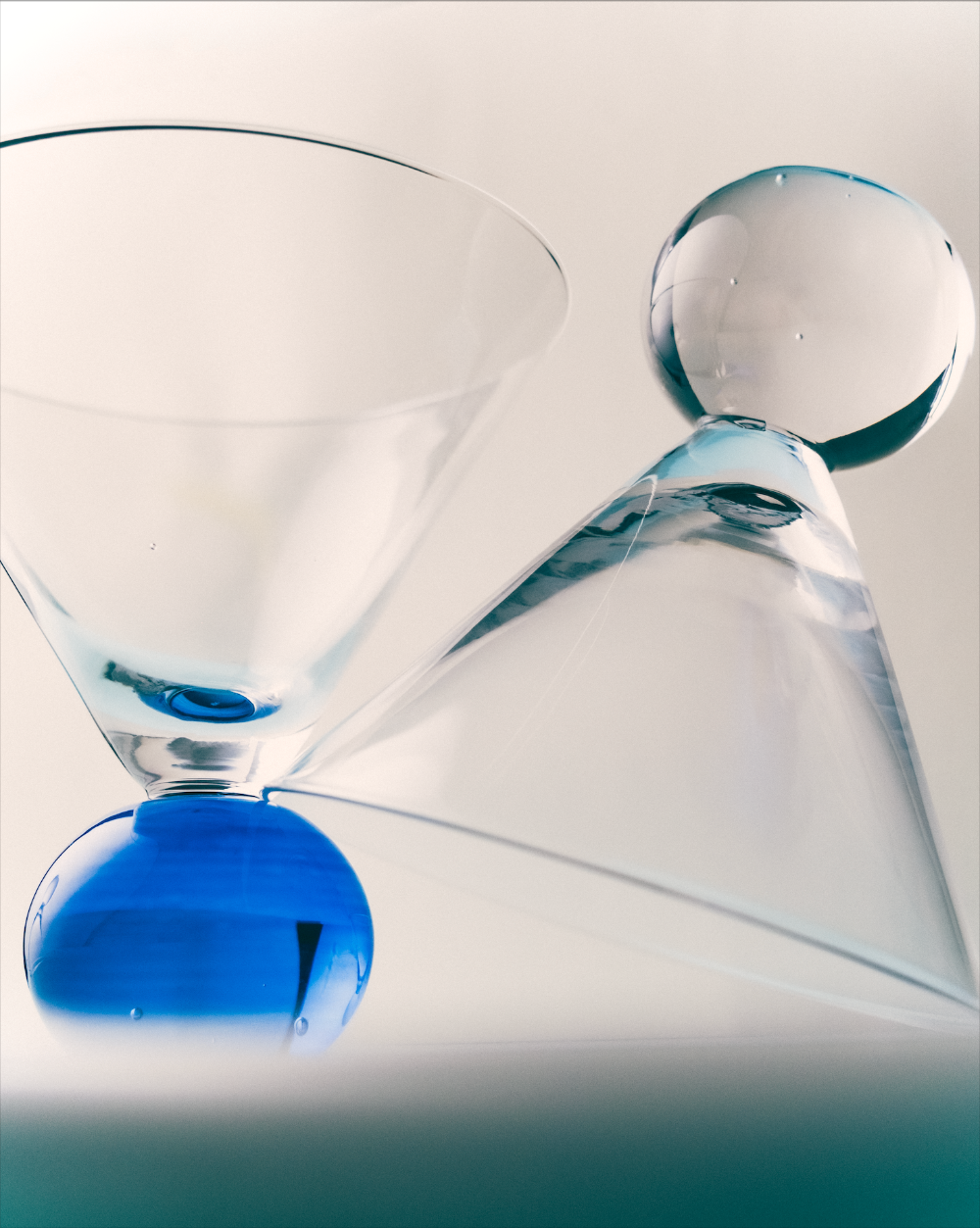 Close-up of a martini glass with blue bobble stem on a white background