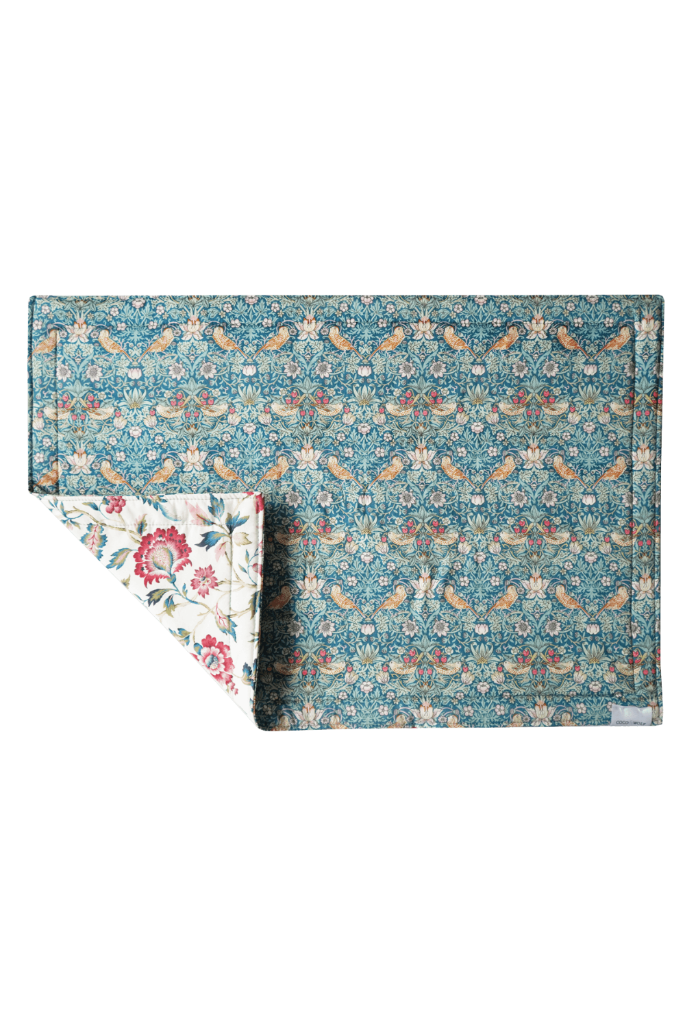 Floral patterned Liberty fabric placemat on a plain background
