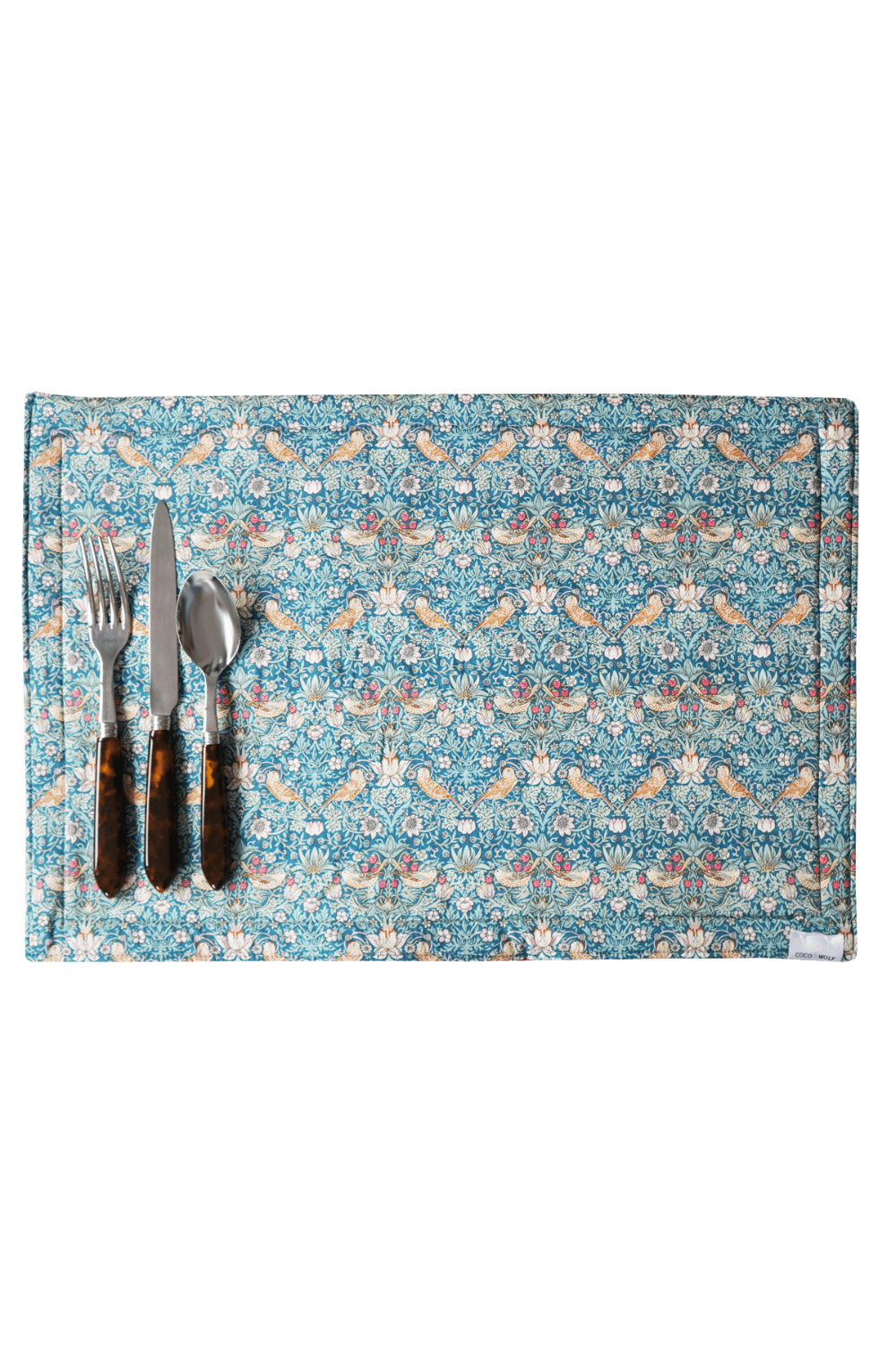 Decorative placemat with floral pattern and cutlery on a matching background