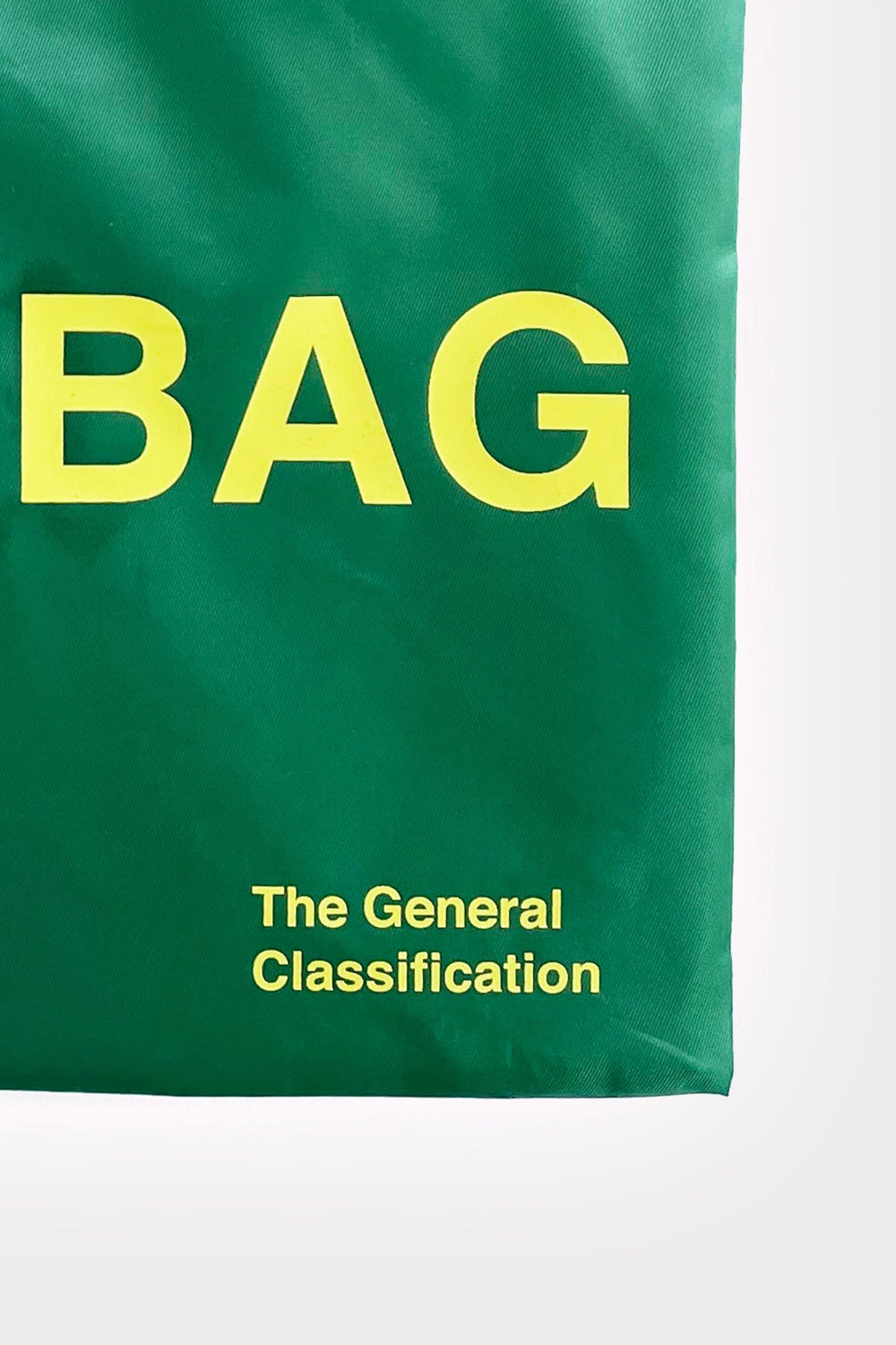 A green bag or pouch with large yellow text reading 'COOL BAG' and smaller text 'The General Classification' on a white background.
