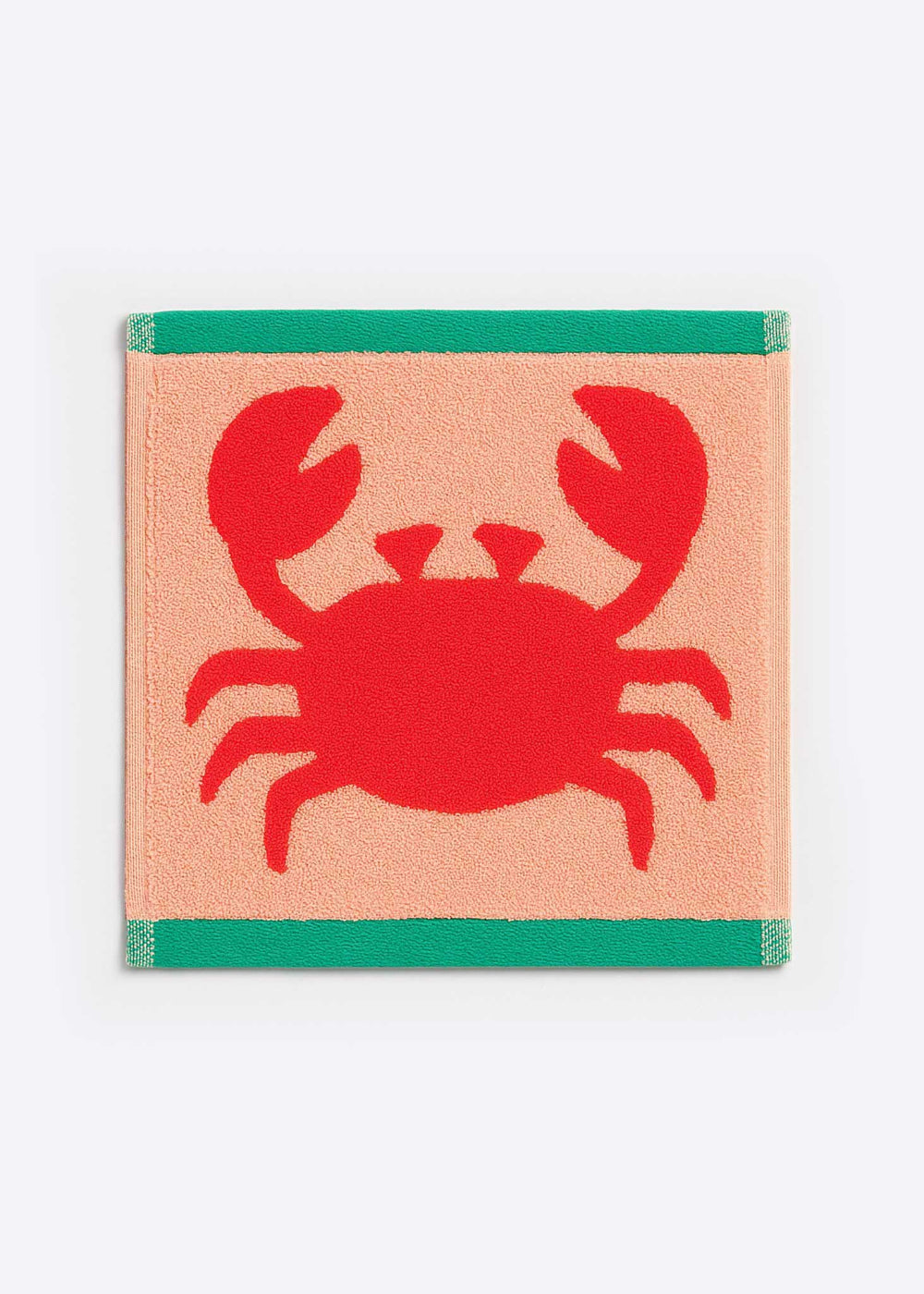 Facecloth with a red crab design on a peach background