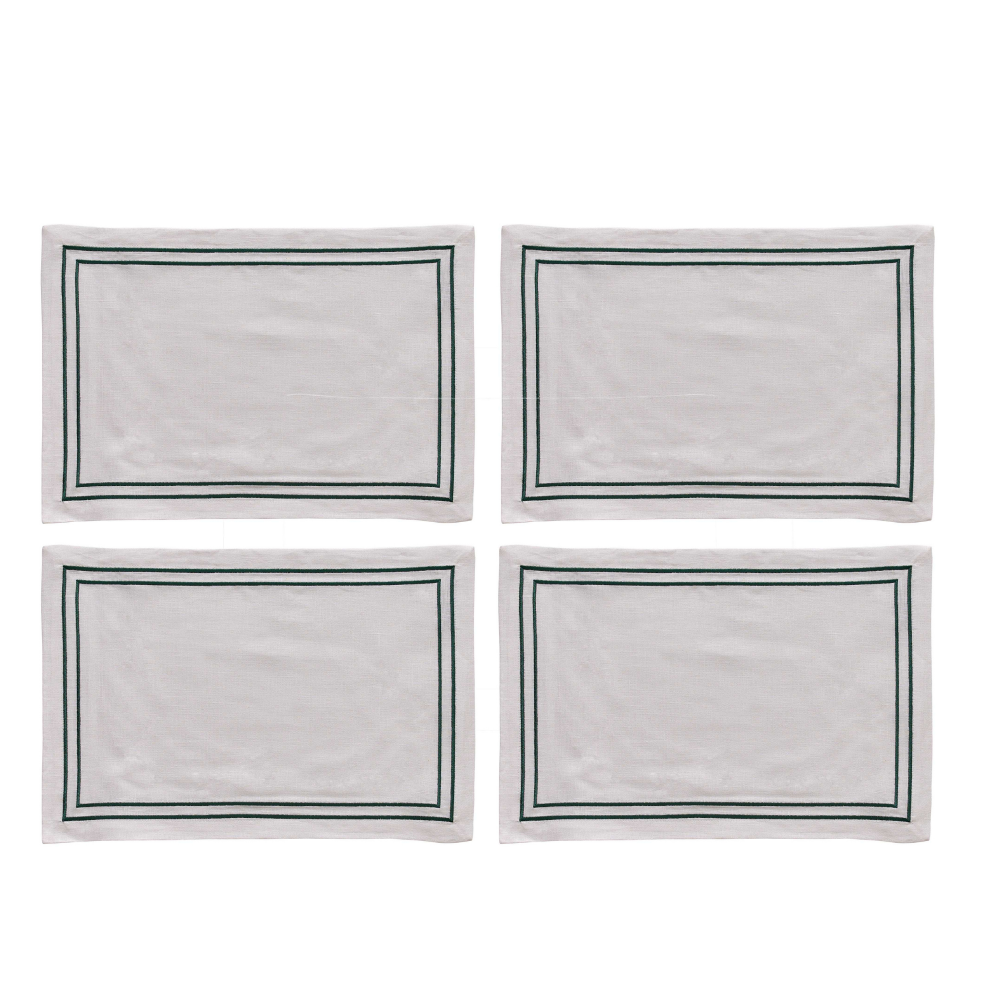 Four white placemats with green borders on a white background
