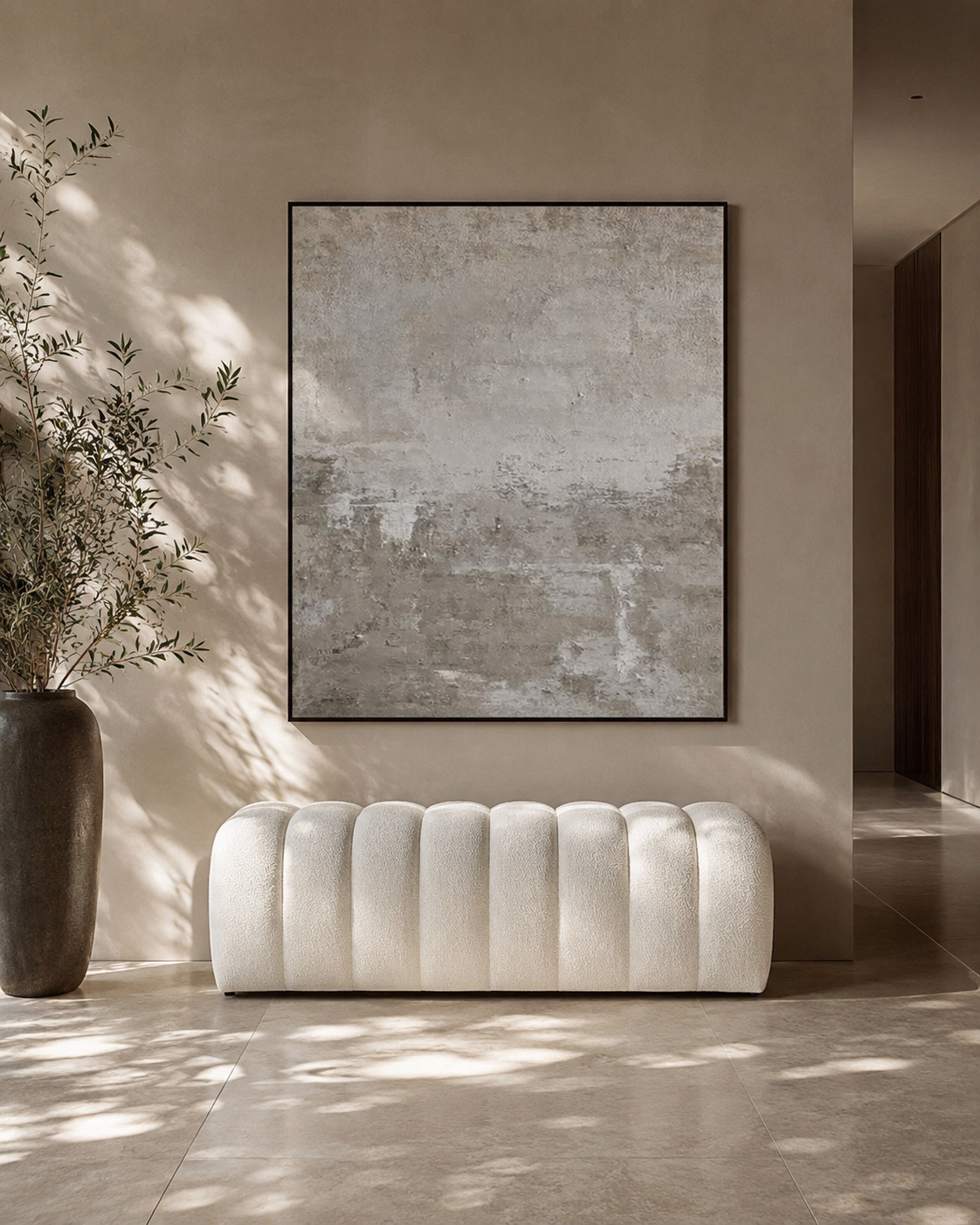 White tufted bench in a room with a large abstract painting on the wall.