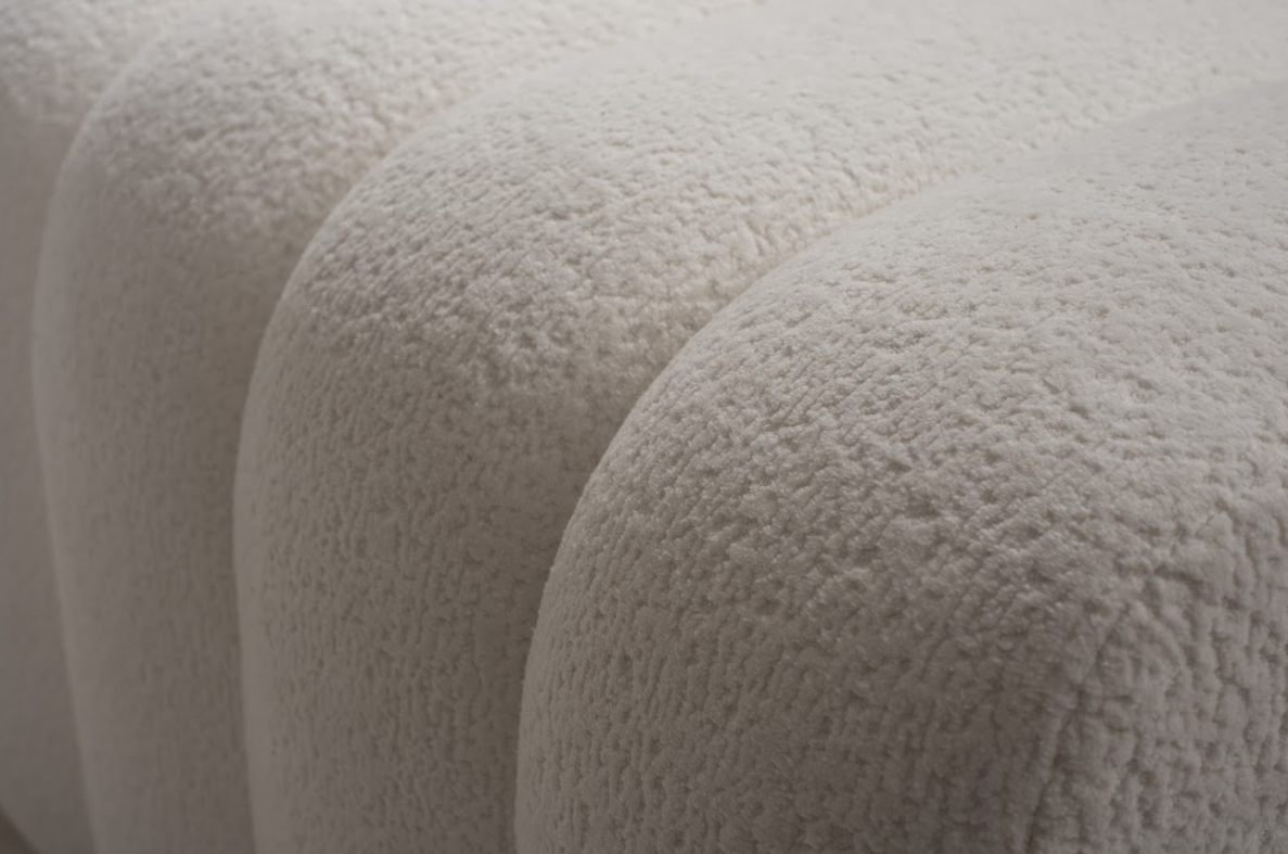 Close-up of textured beige fabric with a soft, plush surface.
