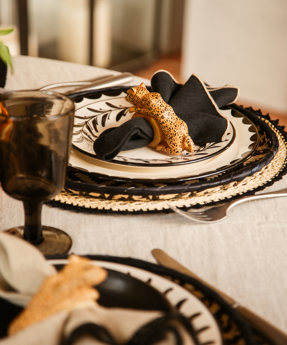 Felino Jaguar Napkin Ring with black cotton napkins on a table setting