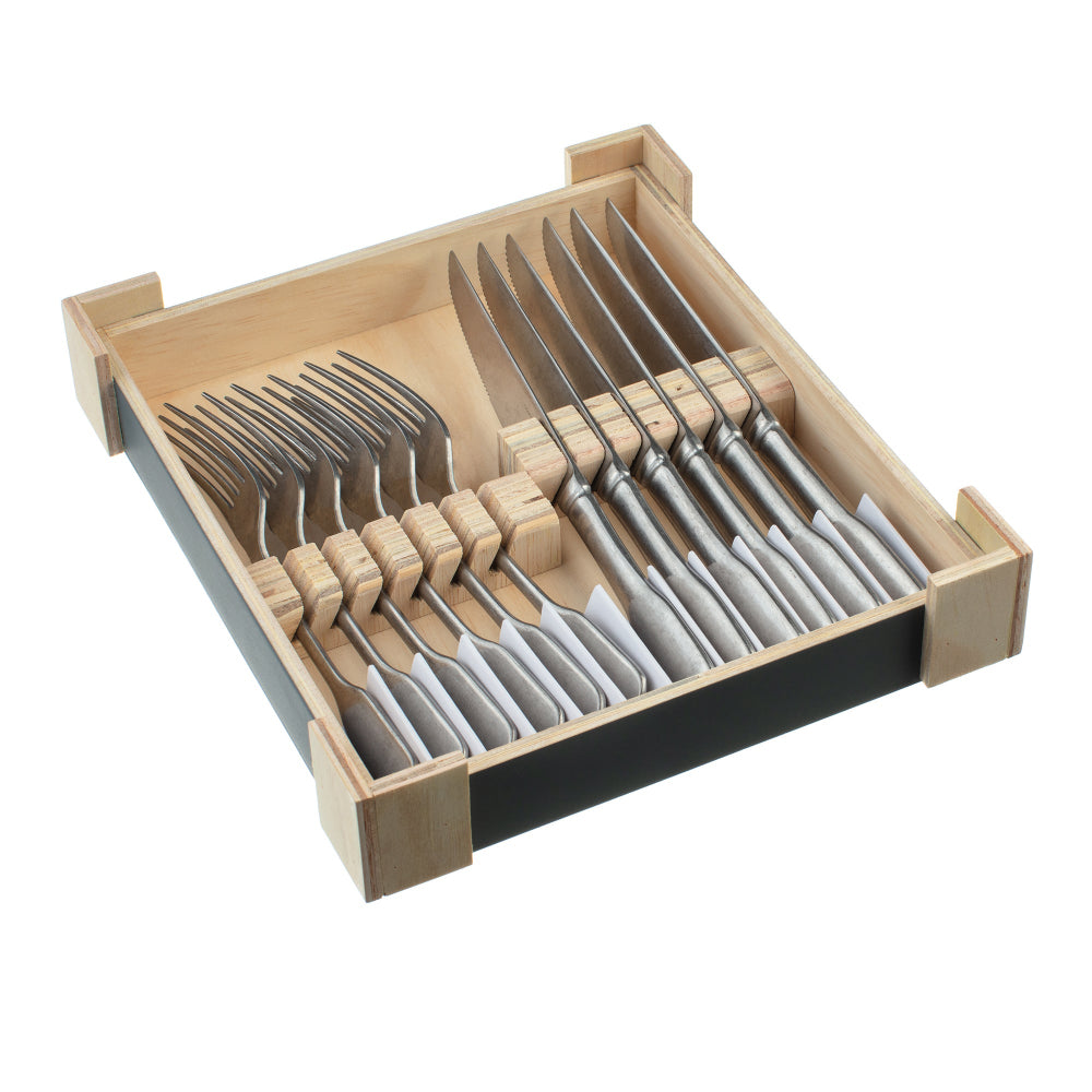 Set of steak knives and forks in a wooden box on a white background