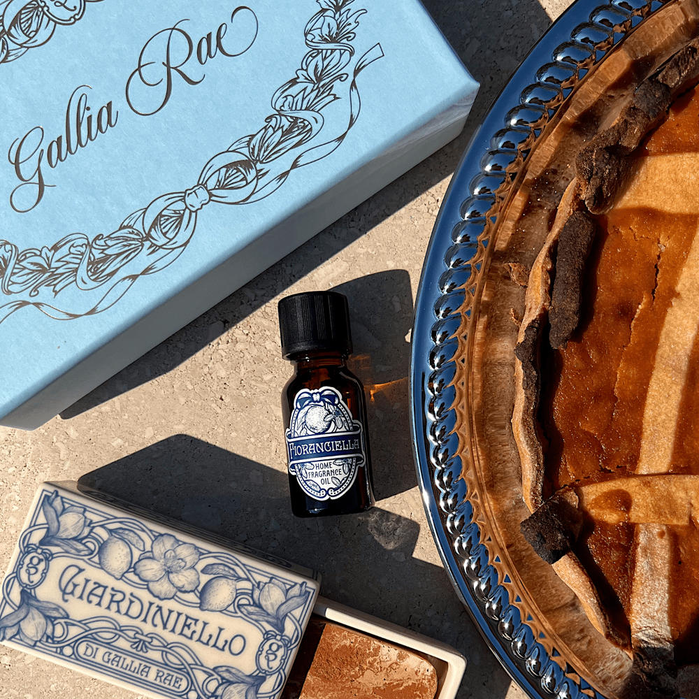 Small bottle of fragrance called fiorancilla on a textured surface with decorative elements.