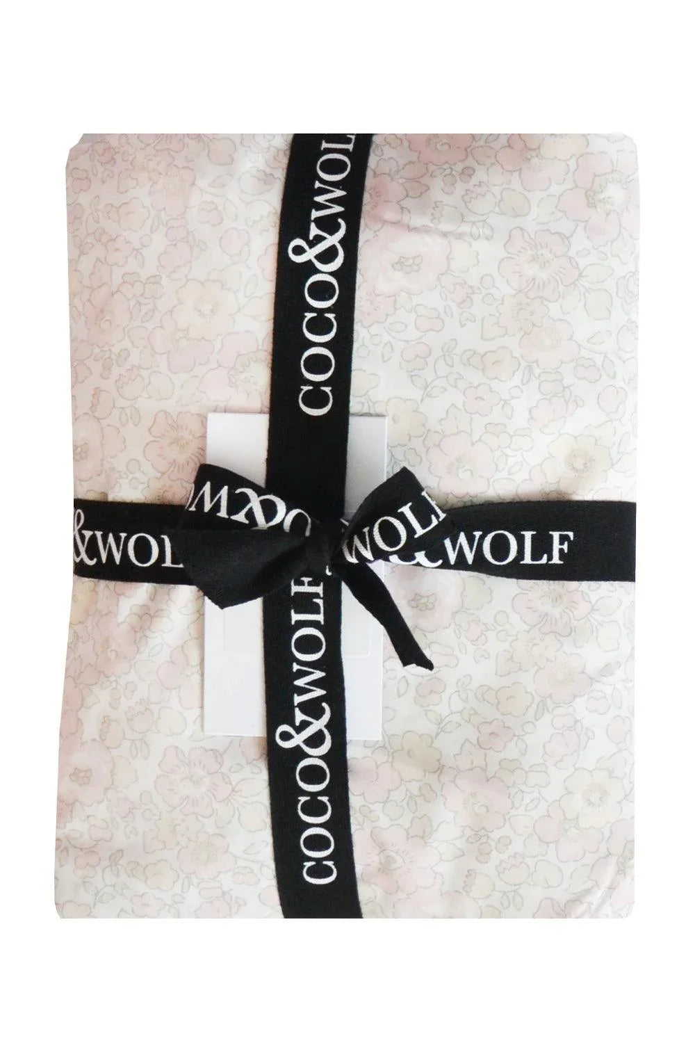 Fitted Sheet wrapped with a black ribbon featuring 'Coco & Wolf' branding.
