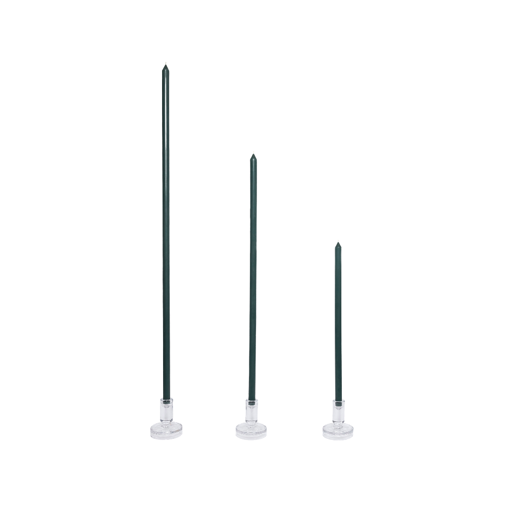 Three forest green tapered candles with clear holders on a white background
