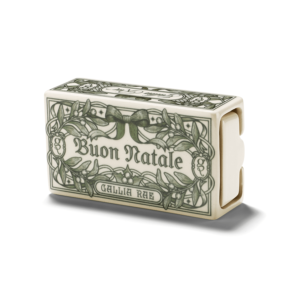 Closed Gallia Rae Buon Natale creamware ceramic matchbox featuring a green botanical Christmas design