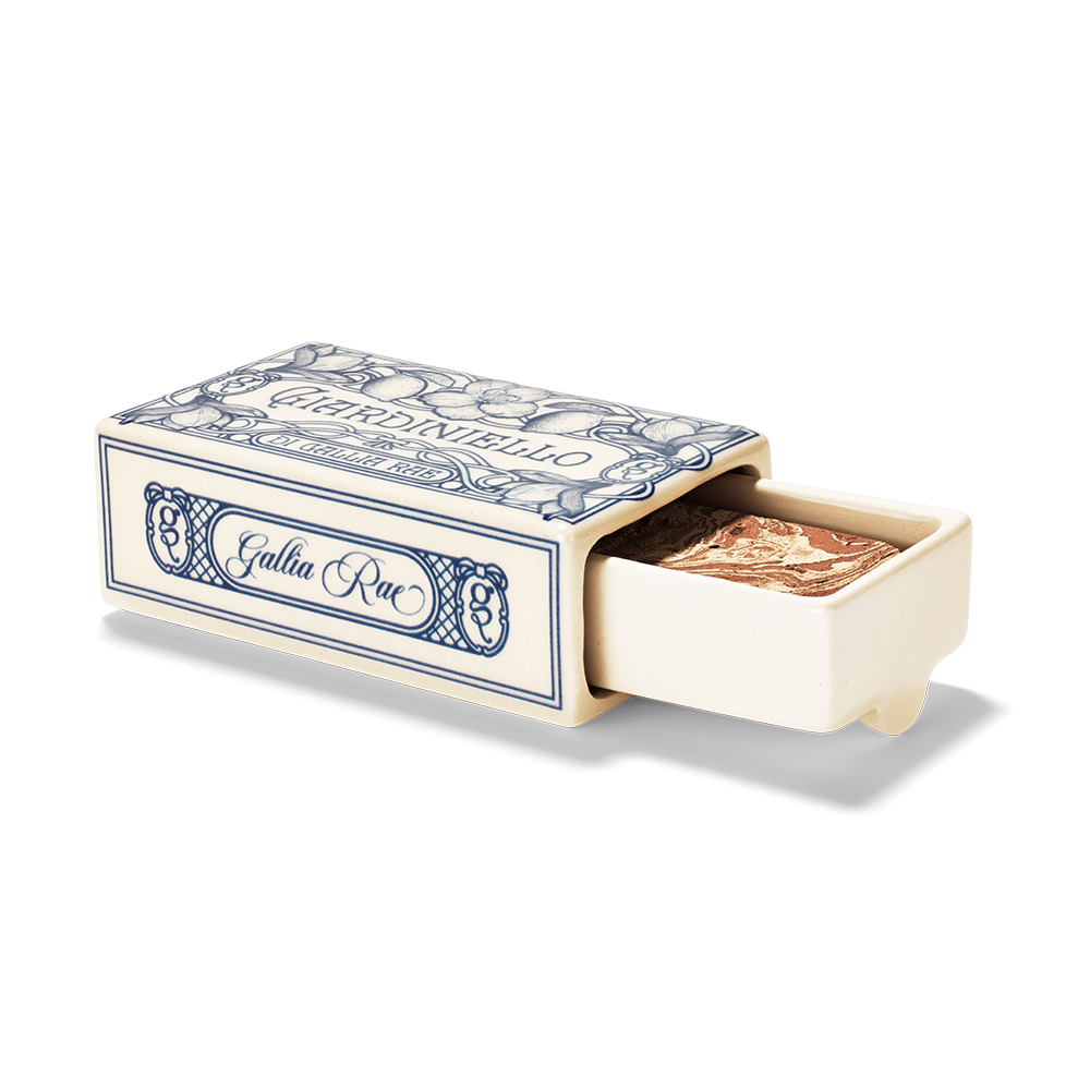 Open ceramic matchbox diffuser with Italian decorative design on a white background