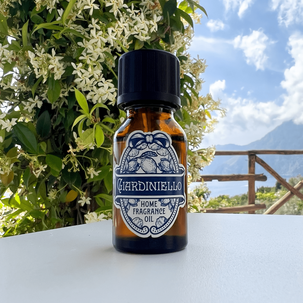 Bottle of GARDINIello home fragrance oil with a scenic background