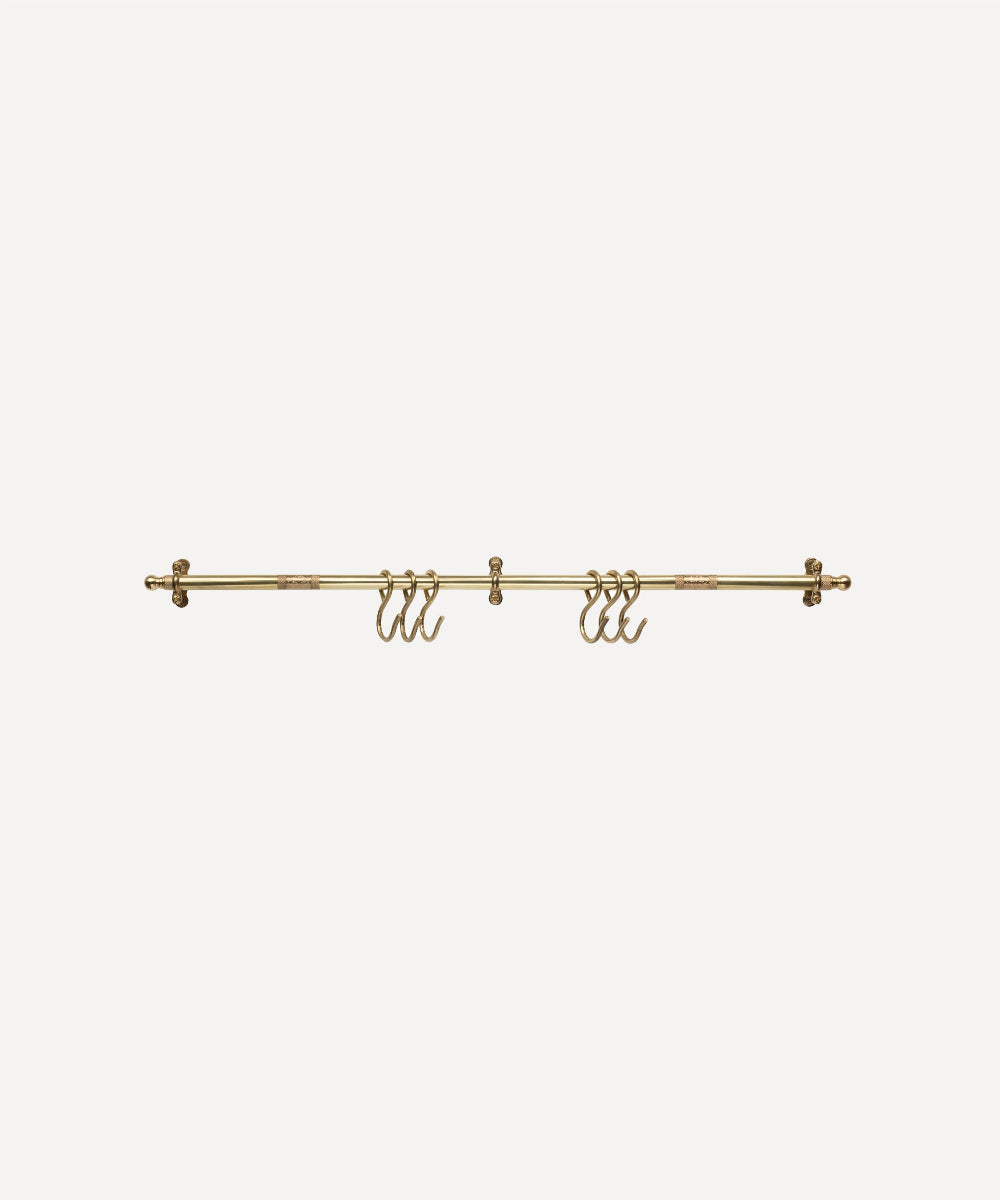 A brass wall-mounted clothing rack with multiple hooks, shown against a plain light gray background.