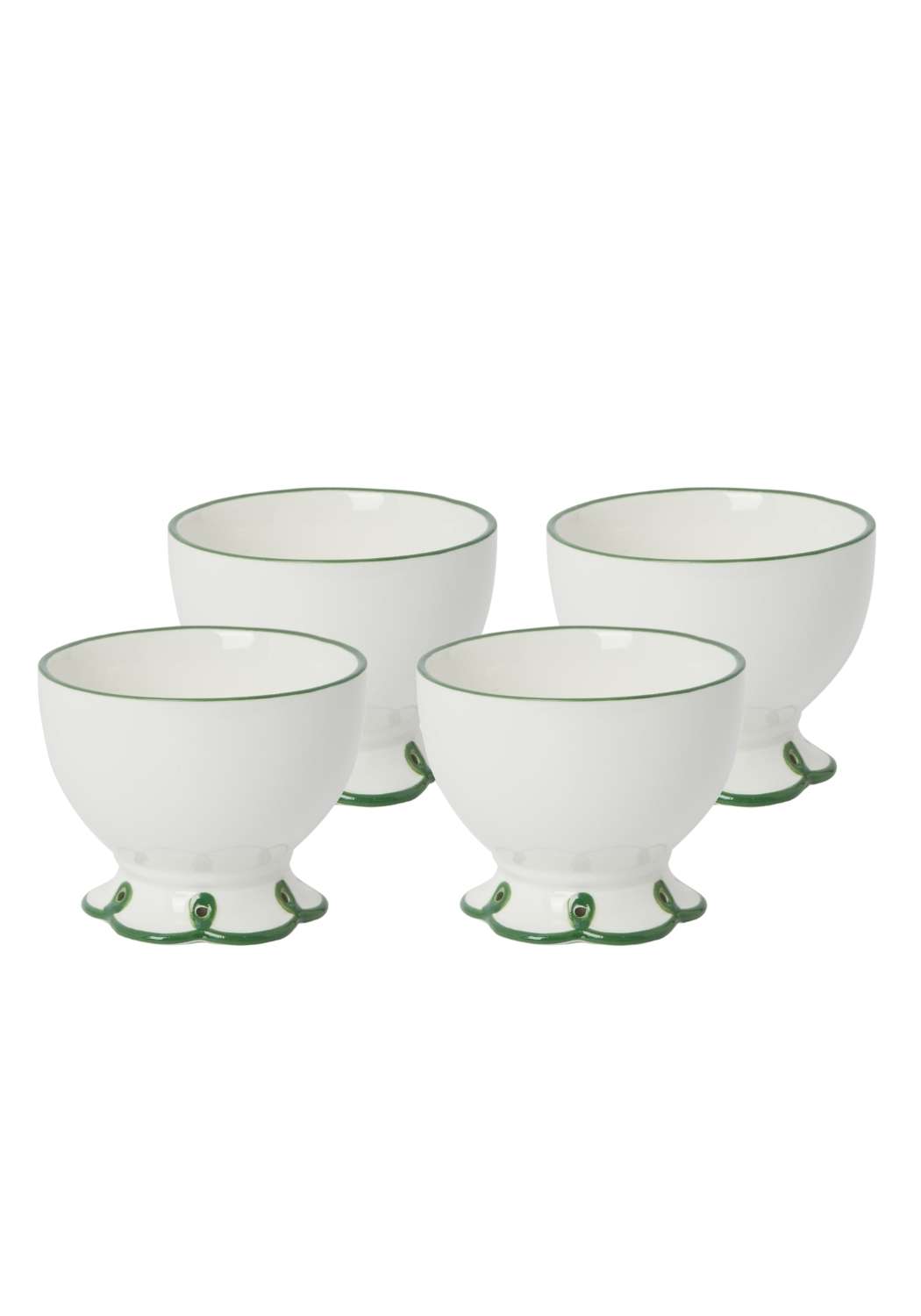 Set of four white ceramic bowls with green decorative rims on a white background