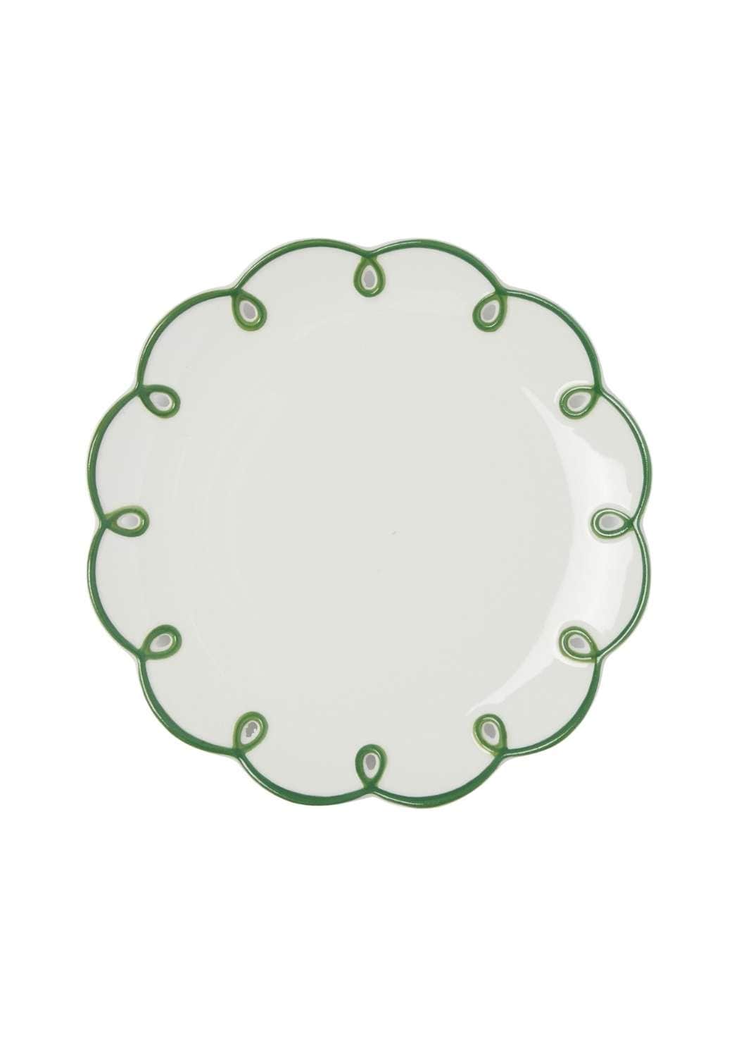 White plate with green decorative scalloped edge on a white background