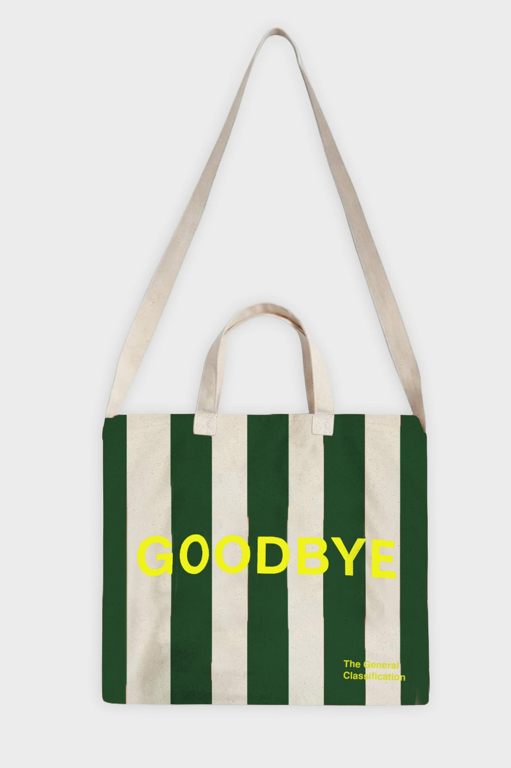 A canvas tote bag with vertical dark green and cream stripes, featuring the word 'GOODBYE' printed in bright yellow across the centre and small yellow text in the bottom right corner, shown against a light gray background.