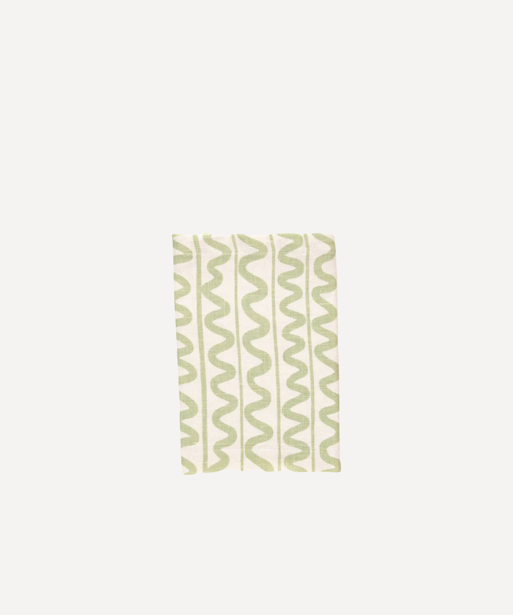 Green Linen wavy lined napkins on a plain background
