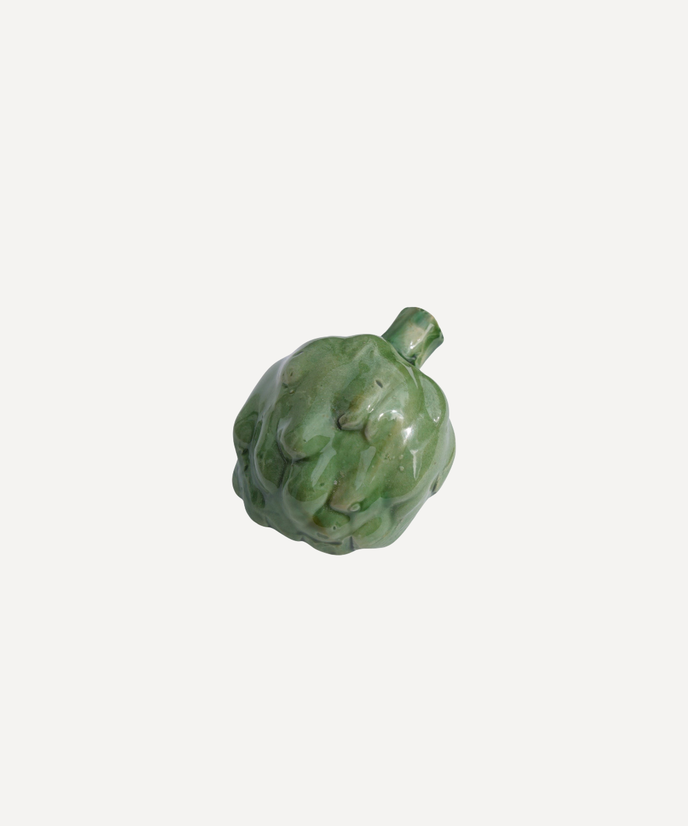Green ceramic artichoke-shaped object on a white background