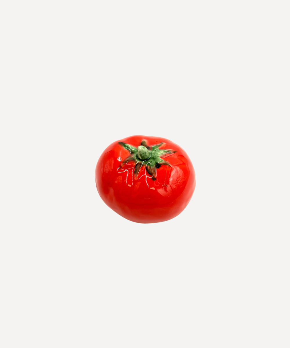 Red ceramic tomato on a white background