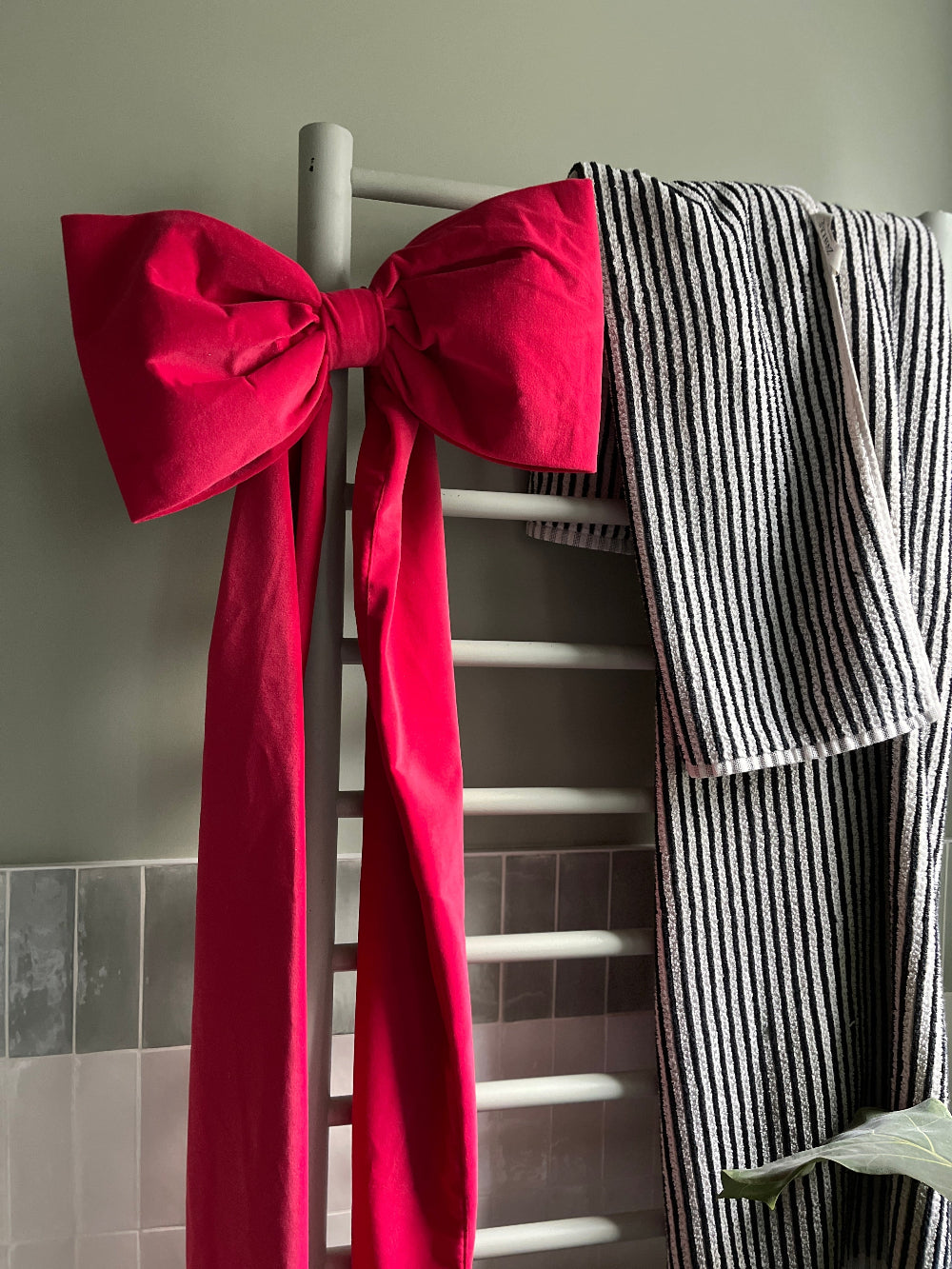 Detail of the handmade hot pink velvet bow and rich upholstery-grade fabric