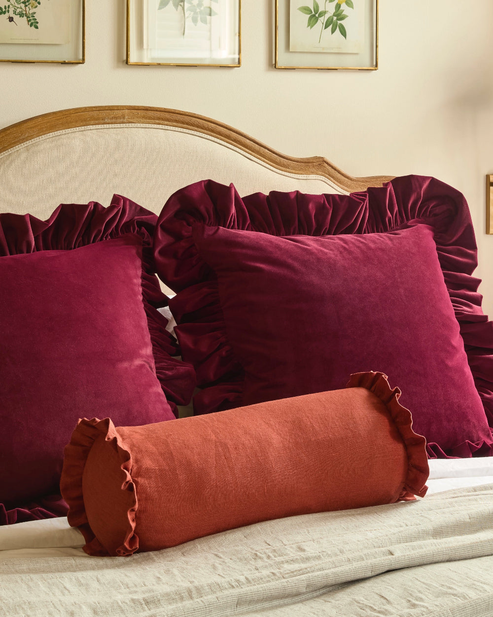 Handmade rust linen bolster cushion with soft ruffled edge